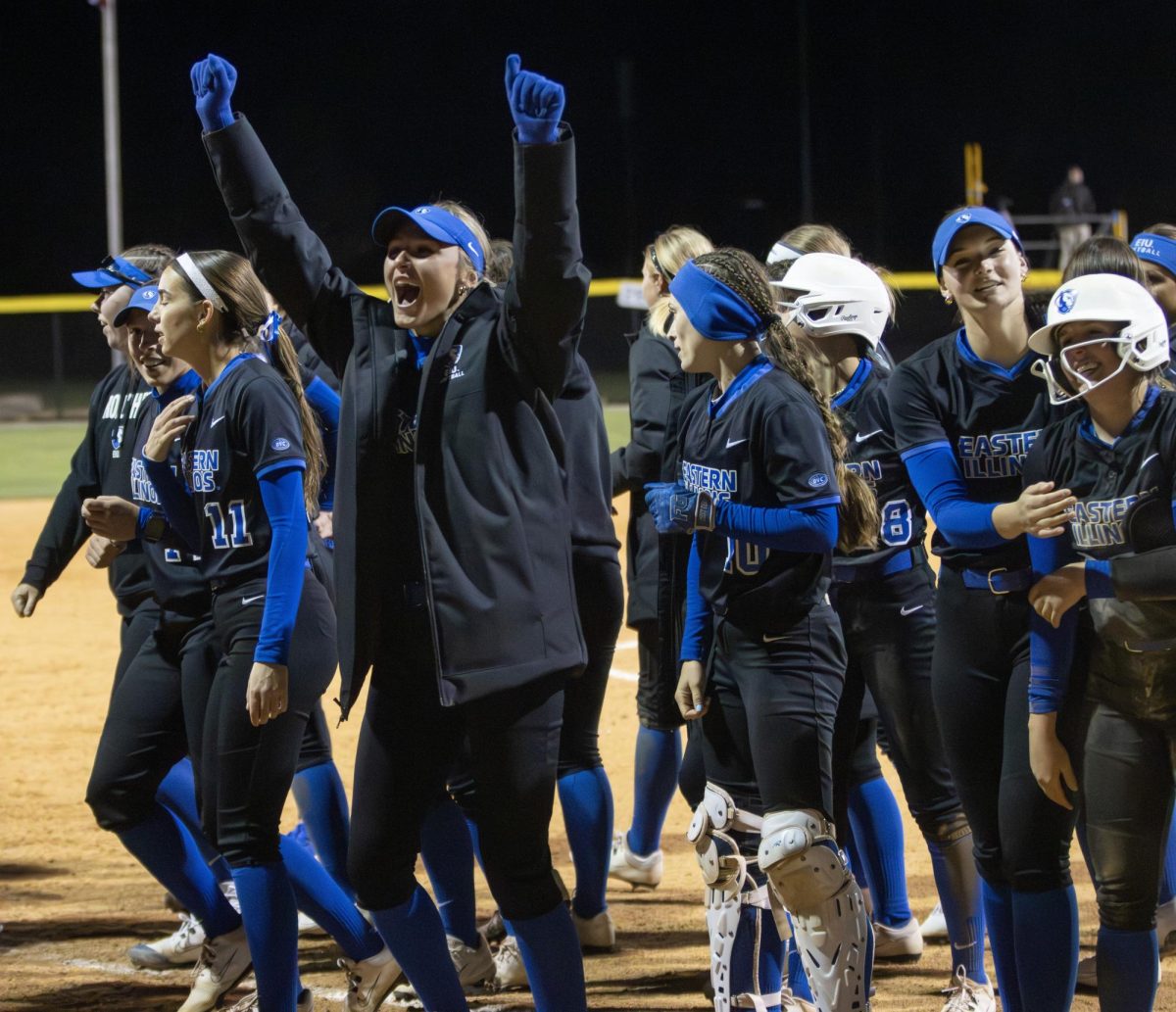 The Eastern Illinois softball team celebrates with the fans in the stands after their 14-inning 12-11 victory against Lindenwood on Friday at Williams Field.