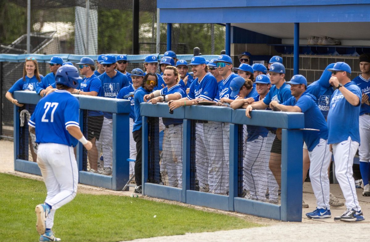 Eastern Illinois University baseball sophomore infielder James Loves jogs back to his dugout after scoring while his team celebrates in Eastern's 9-6 win over Southern Indiana Sunday afternoon at Frost Field at Coaches Stadium. 