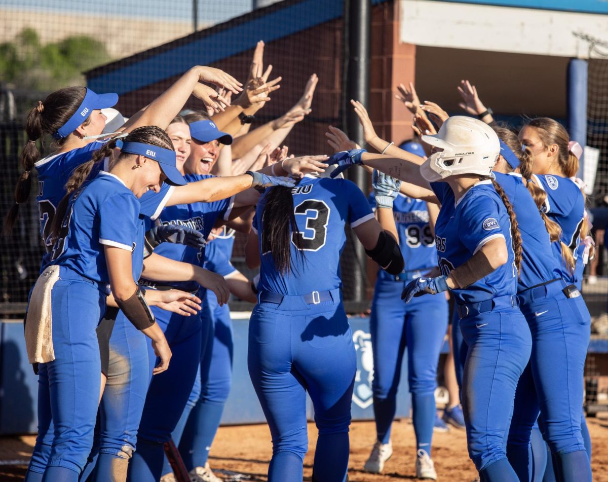 Eastern Illinois University softball sophomore utility player Abbi Hatton runs through a tunnel of her teammates after she hit a three-run home run during EIU’s 6-3 win over University of Illinois Chicago at Williams field on Wednesday.