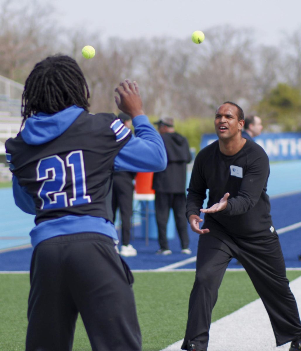 EIU redshirt senior defensive back Kaleb Lyons plays catch with Zach Baillie, a participant of the Beautiful Lives Project on Wednesday at O'Brien Field.