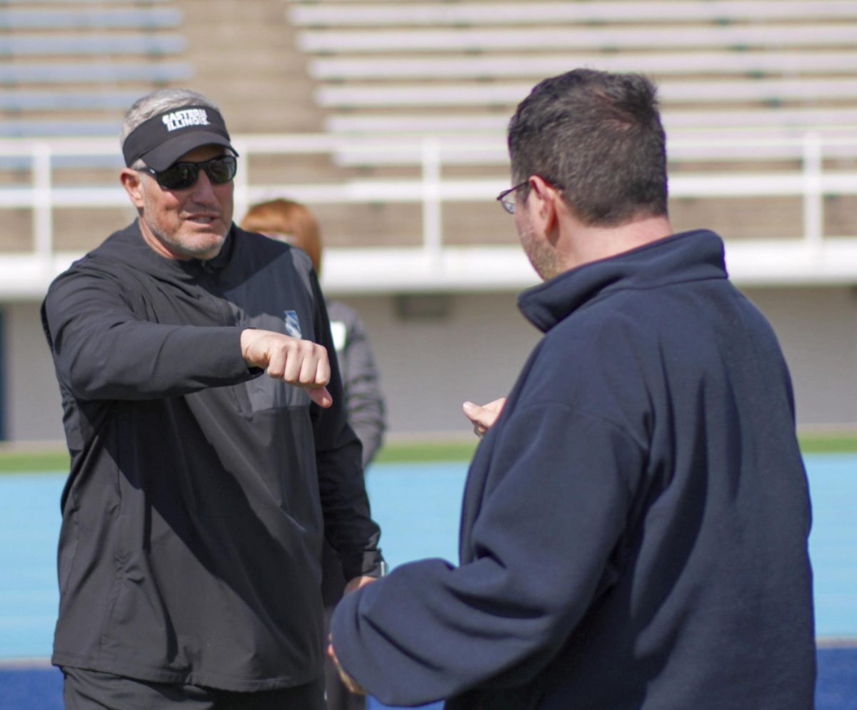 EIU football head coach Chris Wilkerson gives a fist bump to Matthew Davis, a participant of the Beautiful Lives Project on Wednesday at O'Brien Field.