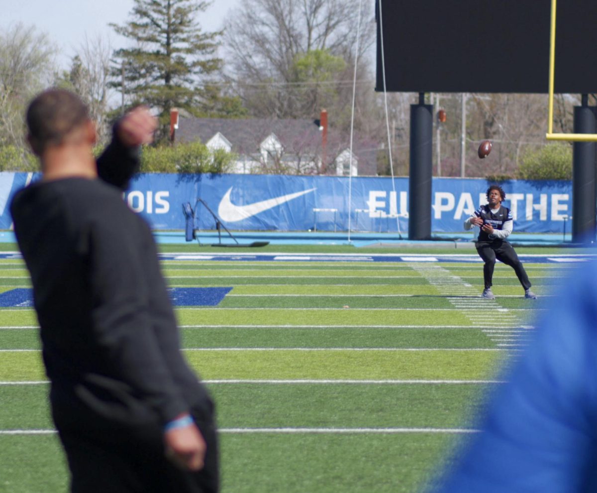Zach Baillie, a participant of the Beautiful Lives Project, throws a pass to EIU senior linebacker Ja'Wuan Nickson at the end of the hour-long event on Wednesday at O'Brien Field.