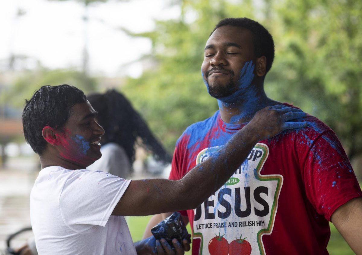 Technology major Krishna Daravath (left), puts pigment onto hospitality entrepreneurship major Terrell Steele (right) at Holi Color Fest on Friday on the Library Quad. Daravath is the president of the EIU Association of International Students (AIS) and vice-president of Indian Student Association (ISA) which hosted the Holi Color Fest. “This festival is related to Hindu mythology and cultural significance. So this is mainly celebrated because a story called Prahlad and Holika,” described Daravath, “there are like new beginnings and kind of sharing this beginning with the friends and family, friendship, forgiveness."