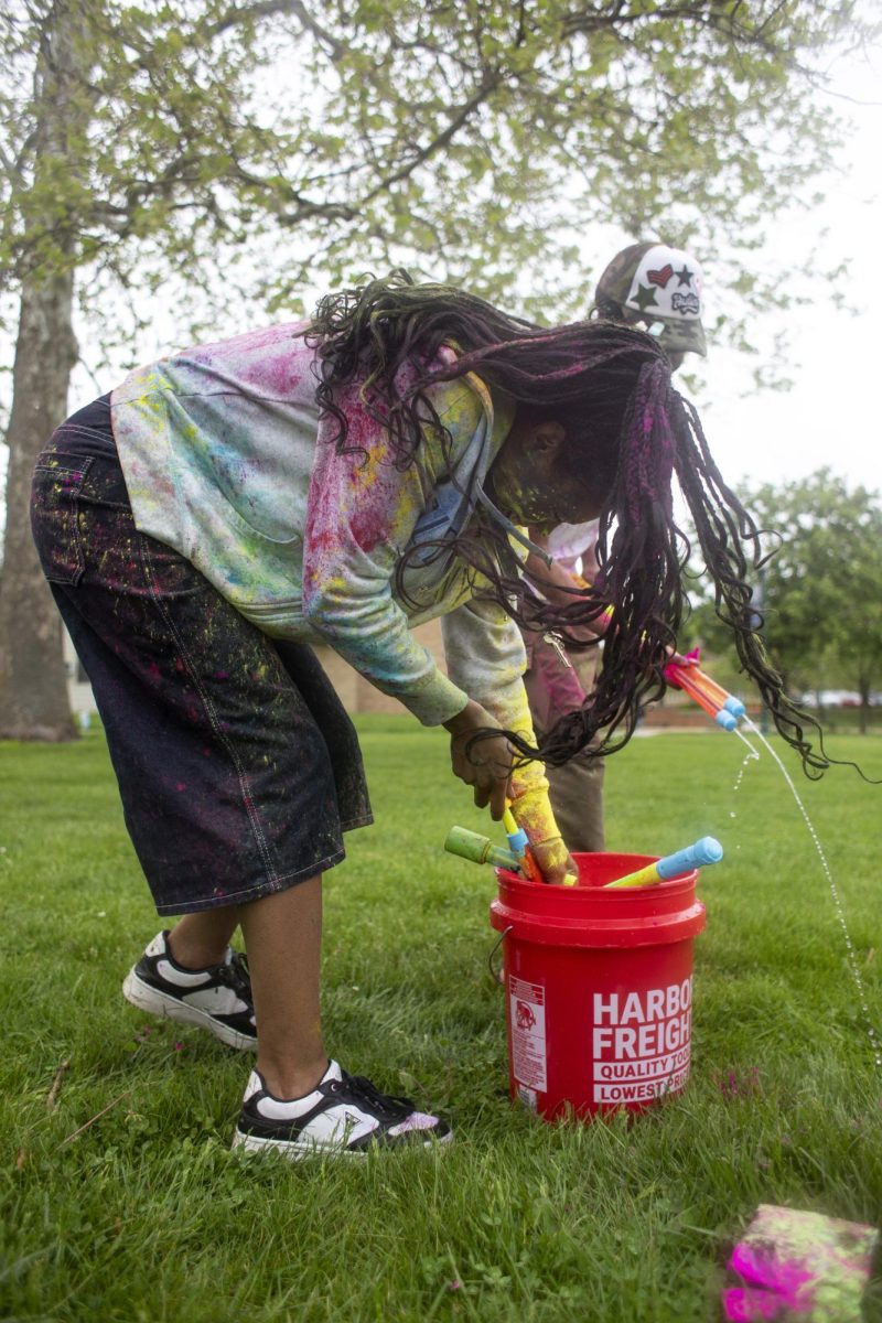 Psychology major Ajah Crawford fills up her water toy at Holi Color Fest on Friday on the Library Quad. “This is the one time I’m actually on time for an event. So I really just wanted to experience this,” Crawford said. “This is kind of like making my dream come true.”