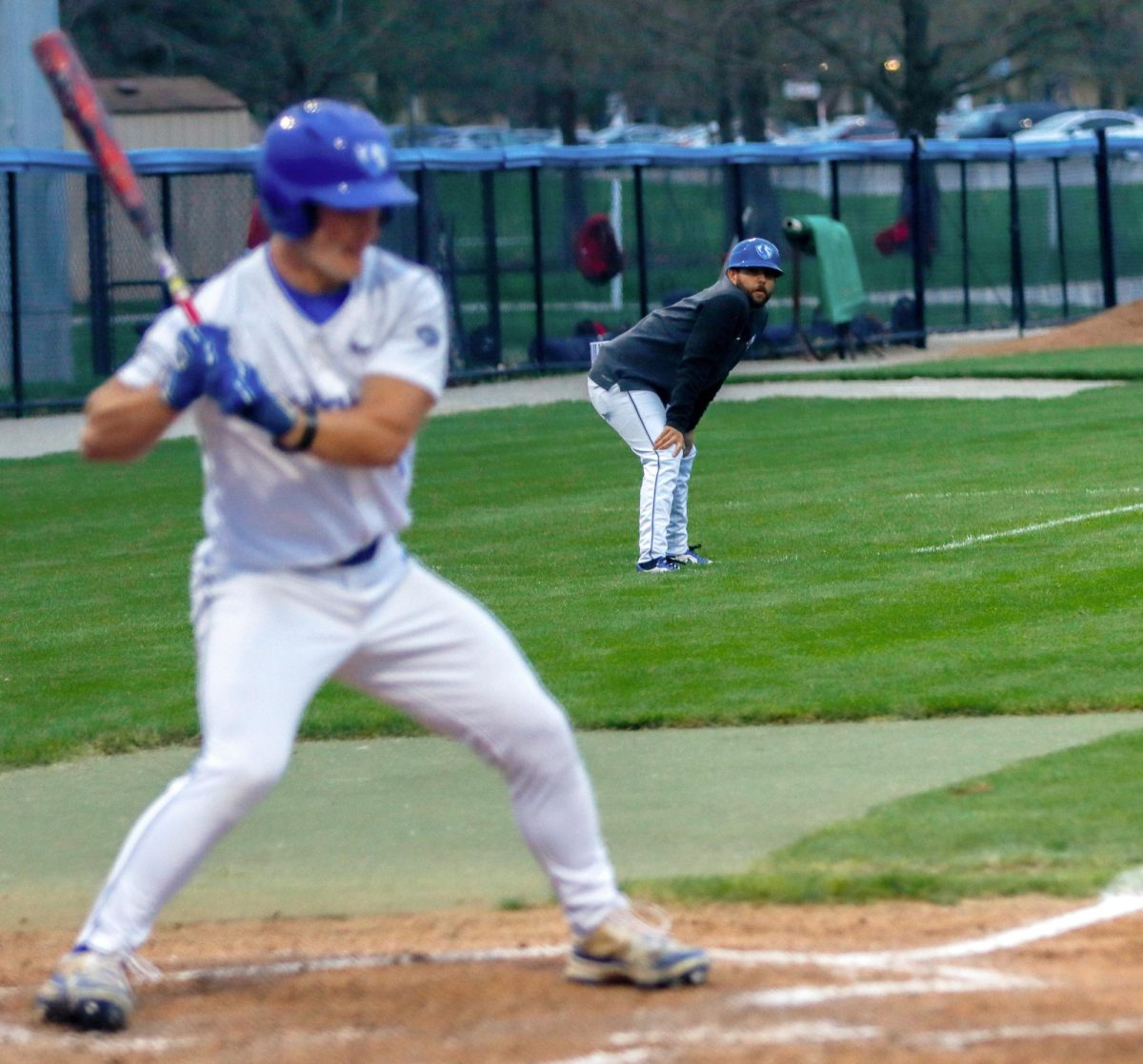 EIU baseball hitting coach and recruiting coordinator Mike Pugliese observes senior outfielder Ethan Rossi in the batter's box during EIU's 13-3 win over Southern Indiana 13-3 at Frost Field at Coaches Stadium Friday.