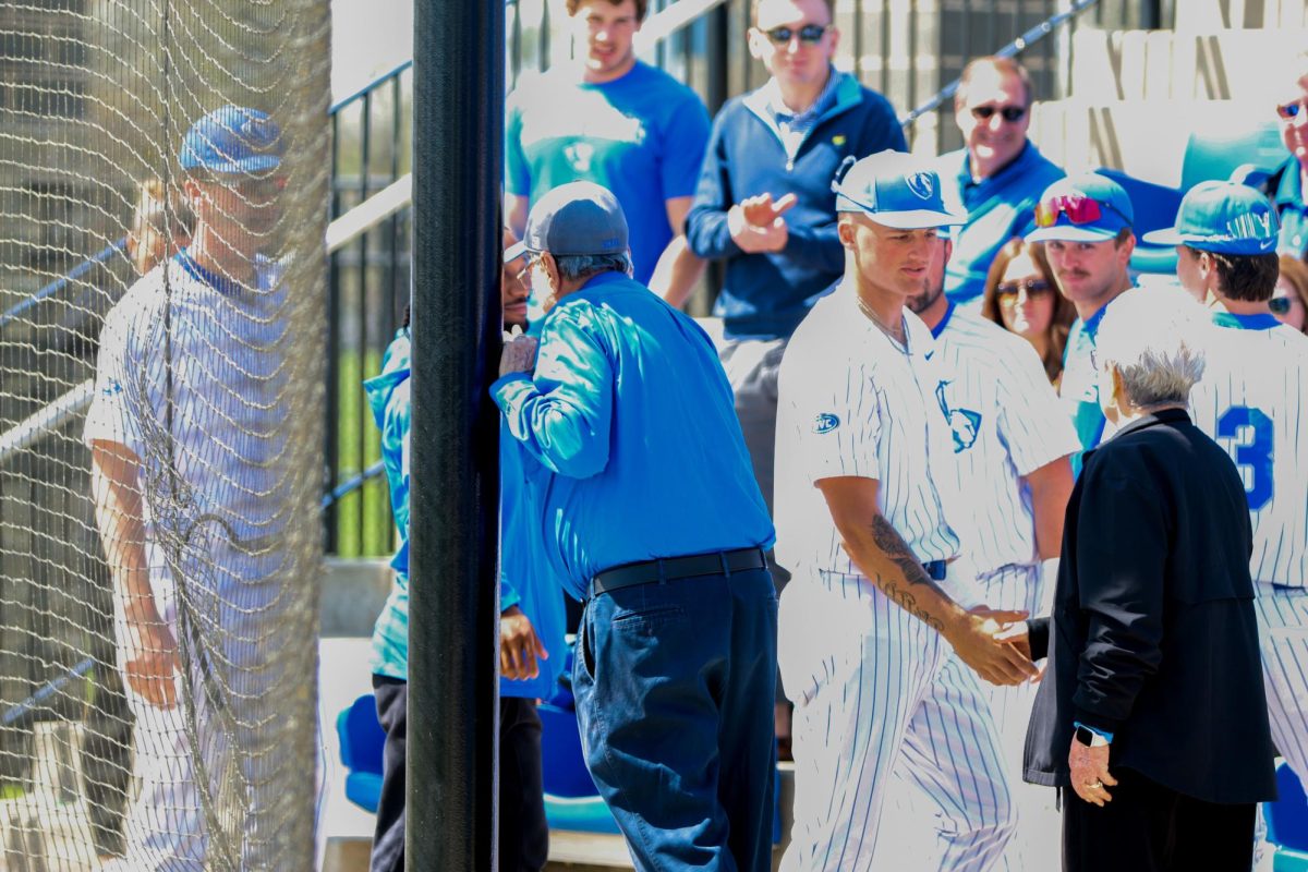 Harry and Gladys Frost are greeted by EIU baseball players in the stands of Frost Field at Coaches Stadium before the Frost Field Dedication Game against Southern Indiana Saturday. Eastern won 3-1.