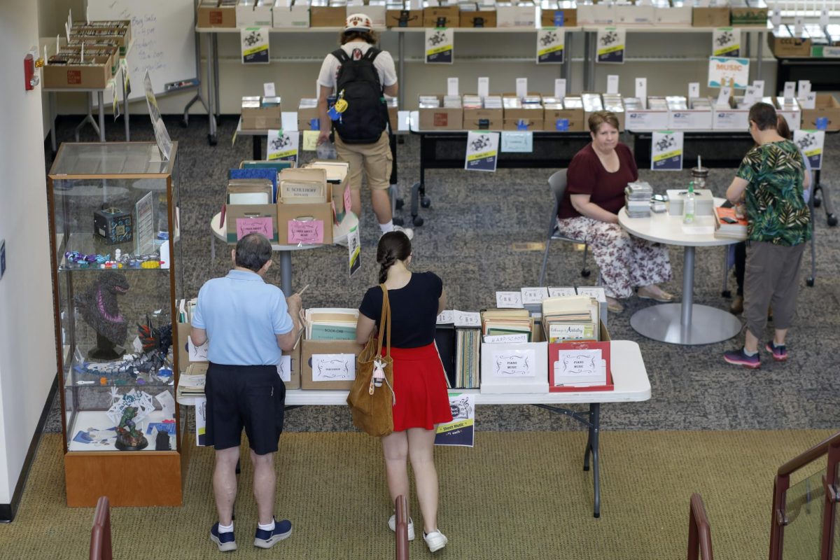 People look through the records, sheet music and CDs at the Media Mayhem event in Booth Library on Wednesday.