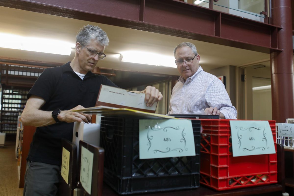 Professor of library services Steve Brantley (left) and Dean of Library Services Brian Keith (right) look through the non-classical record section at the Media Mayhem event at Booth Library on Wednesday afternoon.