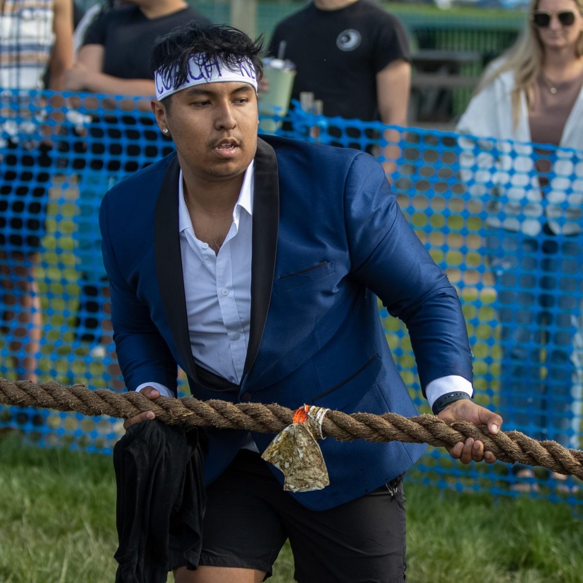 Sigma Phi member, Kevin Ortiz dries the rope before the start of the Tugs event during Greek Week across the campus pond on Wednesday afternoon. Sigma Phi was paired up with Sigma Kappa and received first place overall in Greek Week.