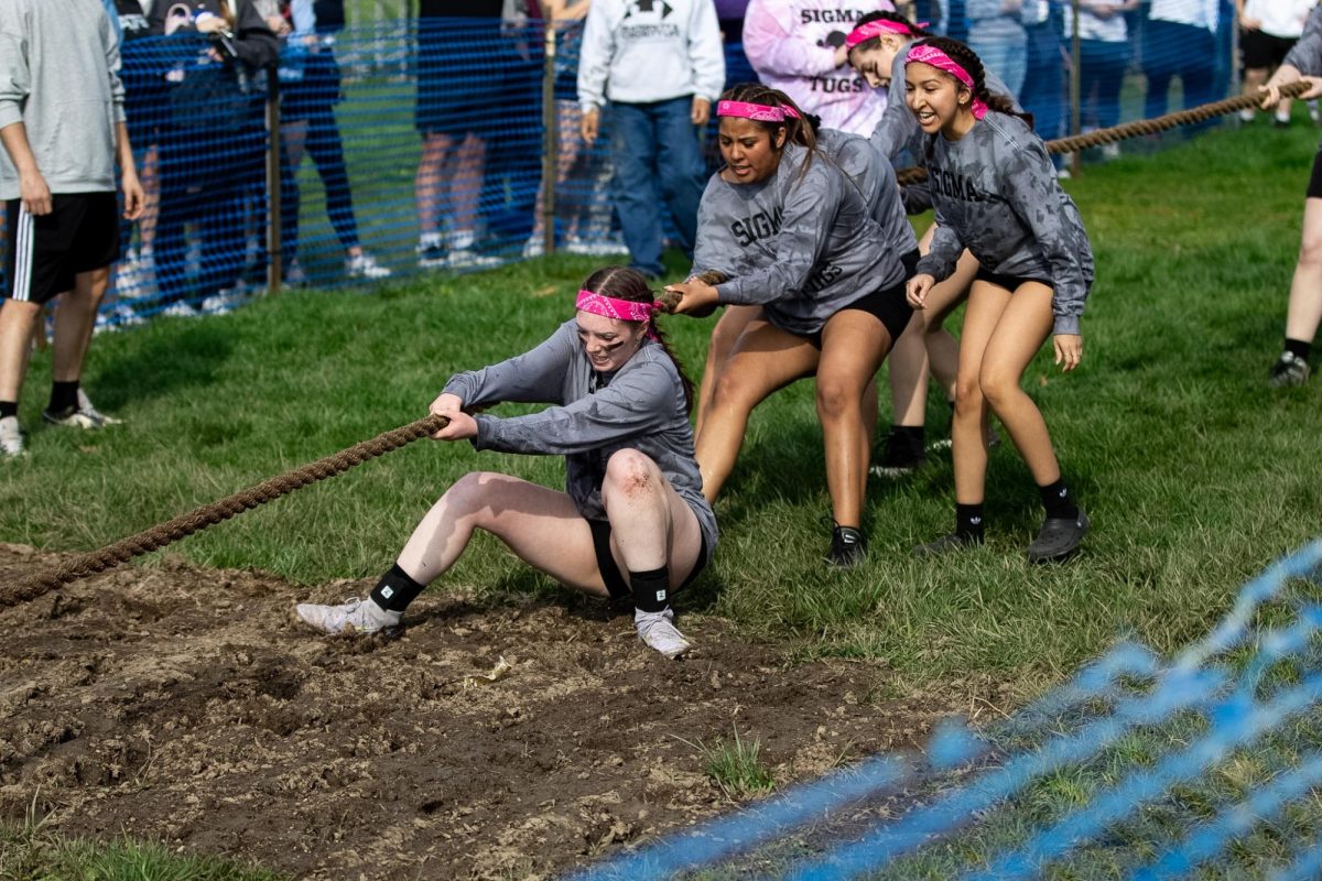 Member of the sorority Sigma Sigma Sigma Sara Street slips and falls in the mud during the Greek Week Tugs match across the campus pond on Wednesday afternoon. Tri Sigma was paired up with Alpha Sigma Tau and Sigma Chi during Greek Week.