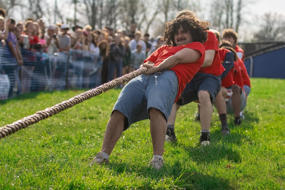 Members of the fraternity Delta Chi lean back and pull on their side of the rope at the Tugs event during Greek Week across the campus pond on Wednesday afternoon.