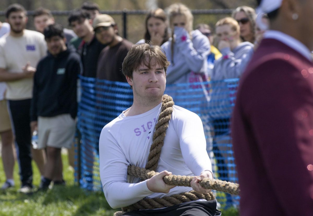 Sigma Phi member Victor Buehler anchors during Tugs finals on Saturday during Eastern Illinois University Greek Week Tug of War across the campus pond. Sigma Pi earned first place in Greek Week with its pairing Sigma Kappa.