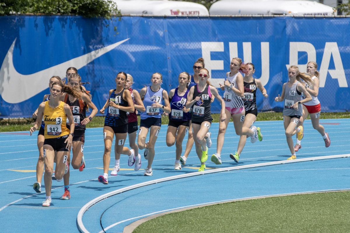 Runners push past the fourth turn during the girls' Class 1A 3200-meter-run at the IHSA Girls State track meet at O'Brien field on Eastern Illinois University's campus in Charleston, Ill. on Saturday afternoon.