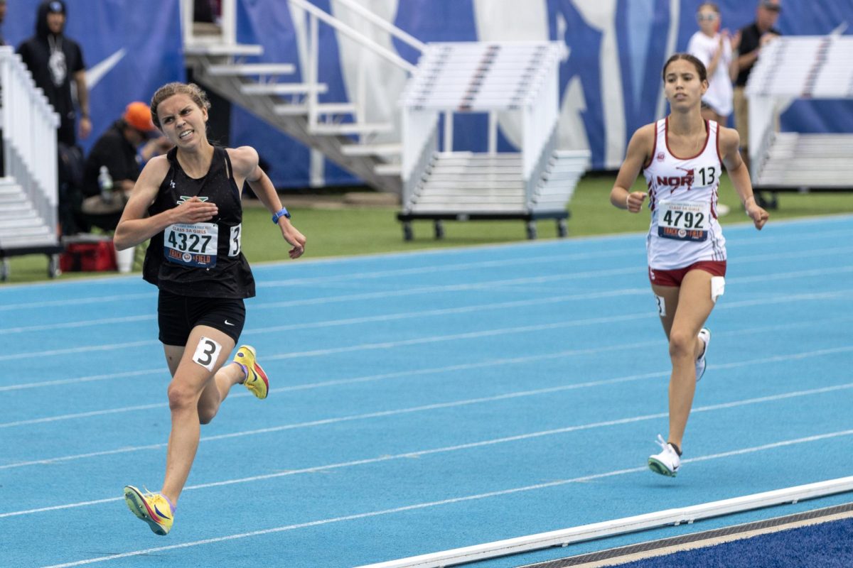 York sophomore Karlin Janowski (left) runs ahead of Plainfield North's Marlie Czarniewski (right) during the Class 3A 3200-meter race at the IHSA girls' state track and field meet at O'Brien Field on Eastern Illinois University's campus in Charleston, Ill. on Saturday.