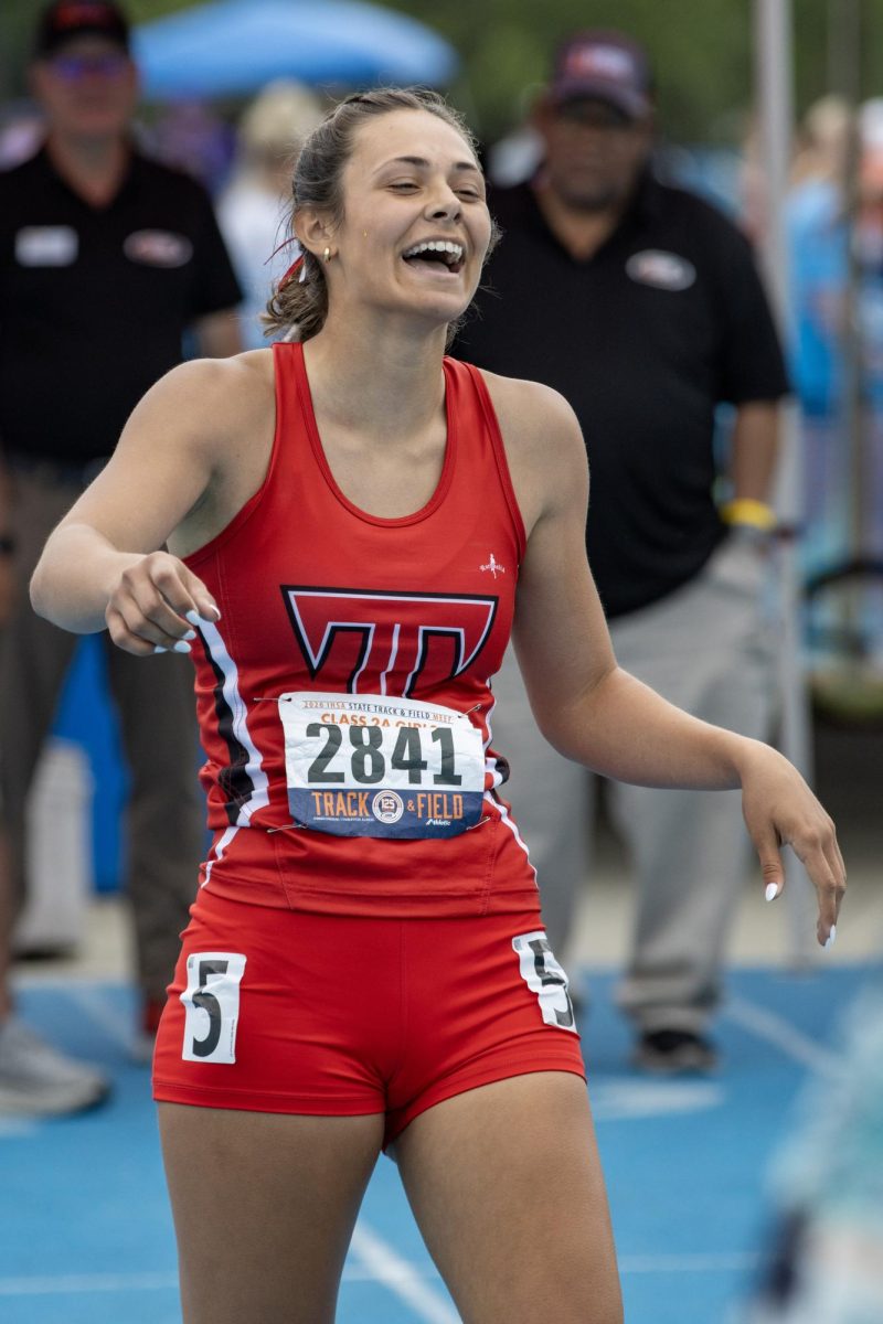 Triad senior Sophia Schardan laughs and smiles after finishing first in the Class 2A 100m race at the IHSA girls' state track and field meet at O'Brien Field on Eastern Illinois University's campus in Charleston on Saturday.