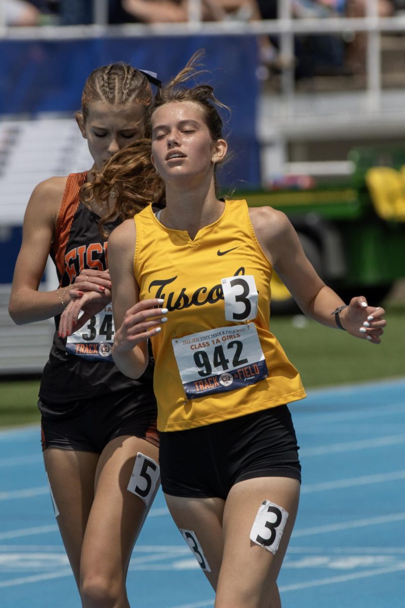 Tuscola senior Kate Foltz (right) finishes next to Fisher freshman Ellie Emberson (left) after the Class 1A 3200-meter race at the IHSA girls' state track and field meet at O'Brien Field on Eastern Illinois University's campus in Charleston on Saturday.