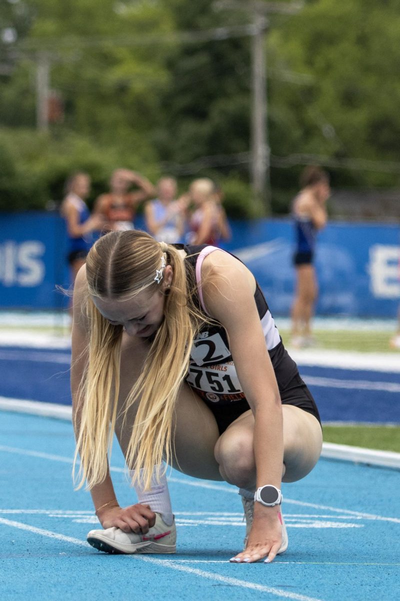 Sandwich senior Sundara Weber crouches down after finishing in second place of the Class 2A 3200-meter race at the IHSA girls' state track and field meet at O'Brien Field on Eastern Illinois University's campus in Charleston on Saturday.