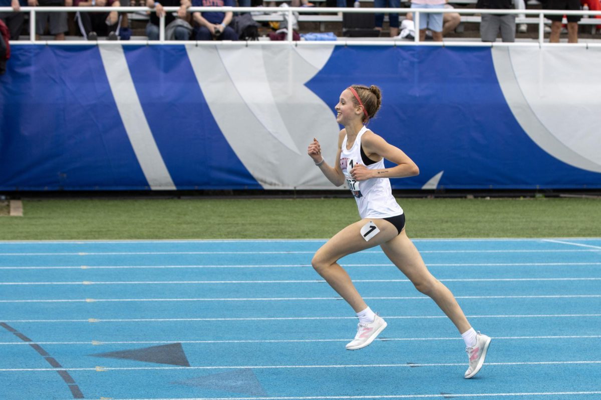 Barrington runner Mia Sirois smiles as she runs the final straightaway of the Class 3A 3200-meter race at the IHSA girls' state track and field meet at O'Brien Field on Eastern Illinois University's campus in Charleston on Saturday.