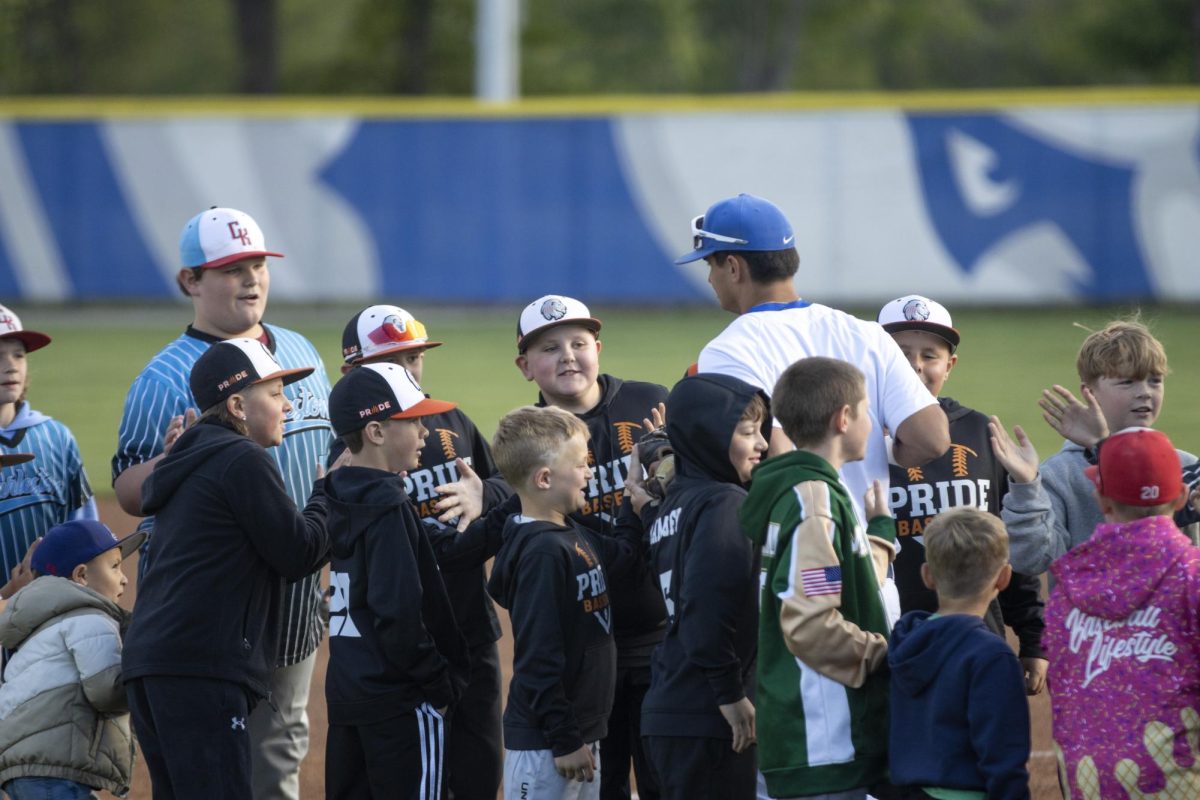 Kids give EIU left fielder graduate student Brett Stanley high fives, after Stanley is announced at the start of the baseball game against SEMO where SEMO lost 5-3 on Friday at Frost Field at Coaches Field.