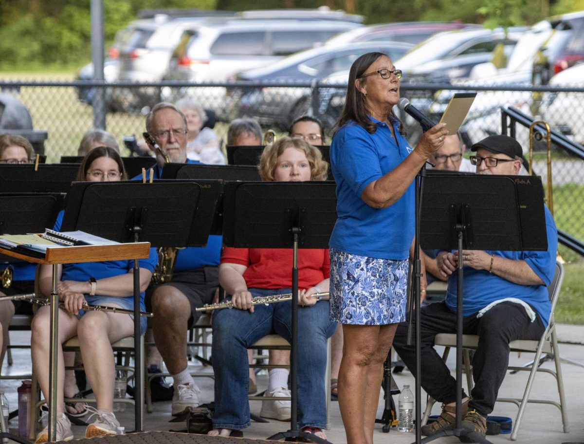 Director of the Charleston Community Band Ginger Stanfield greets the audience before its weekly performance at Kiwanis Park on Thursday.