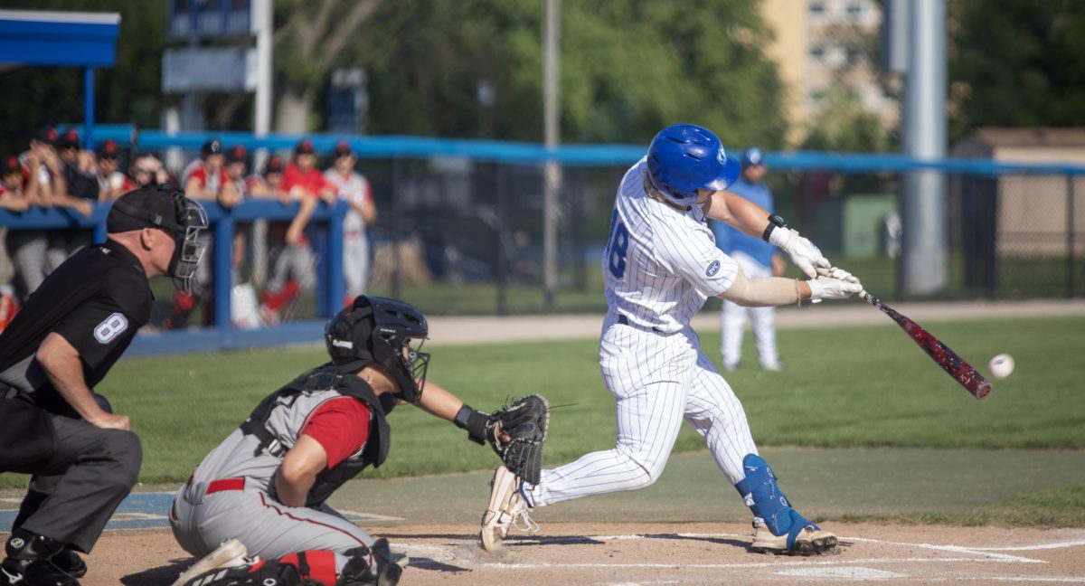 Graduate infielder Chris Worcester (right) hits a pitch while Southern Illinois Edwardsville junior catcher Sean Kang (left) awaits the pitch during EIU baseball’s loss to SIUE at Frost Field on Saturday.
