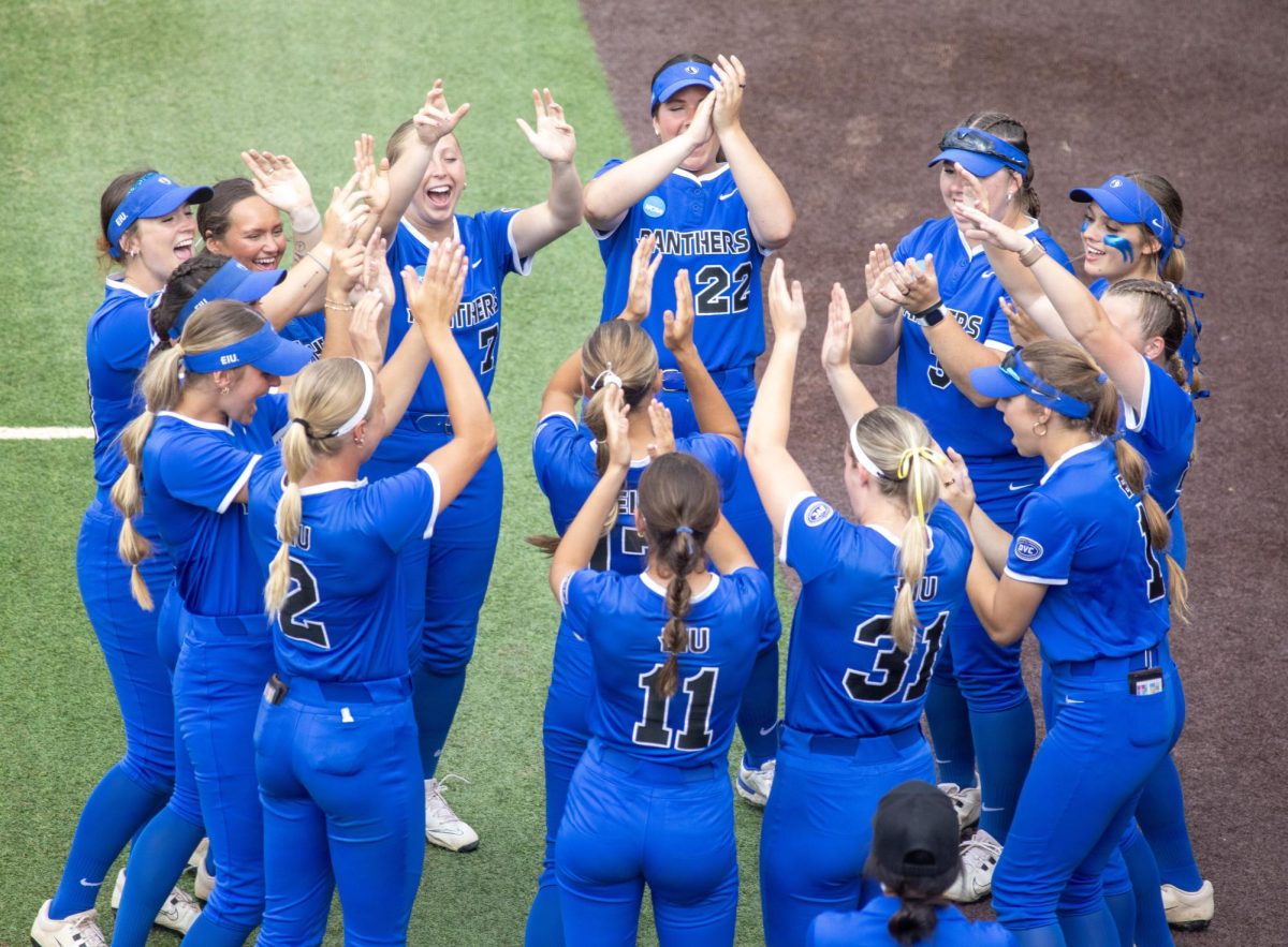 The Eastern Illinois University softball team huddles and claps together as their names are read off before EIU’s 16-0 loss to Oklahoma State University in the second game of the NCAA Stillwater Regional on Friday.