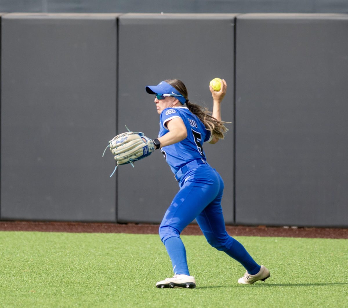 Eastern Illinois University softball senior outfielder Marybeth Dyson goes to throw in a ball after catching it in the outfield during EIU’s 16-0 loss to Oklahoma State University in the second game of the NCAA Stillwater Regional on Friday.