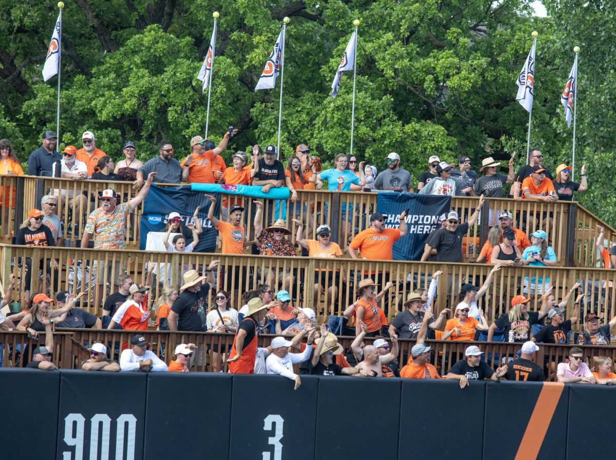 Oklahoma State University softball fans make OSU with their arms in the outfield after a home run during EIU’s 16-0 loss to Oklahoma State University in the second game of the NCAA Stillwater Regional on Friday.