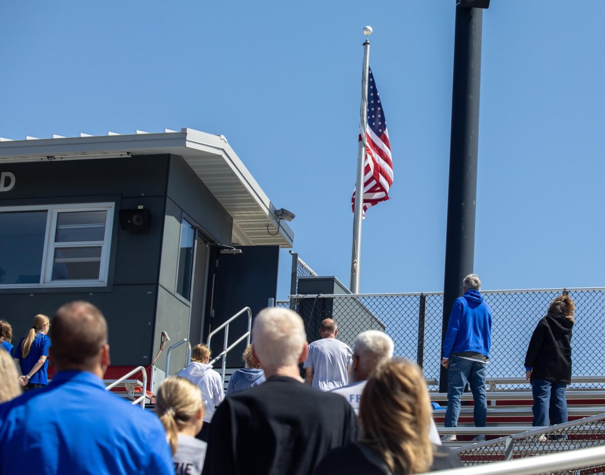 Eastern Illinois University softball fans stand for the national anthem before the first game of the OVC championship at OSF Healthcare Field at the Louisville Sports Sluggers Complex on Saturday.