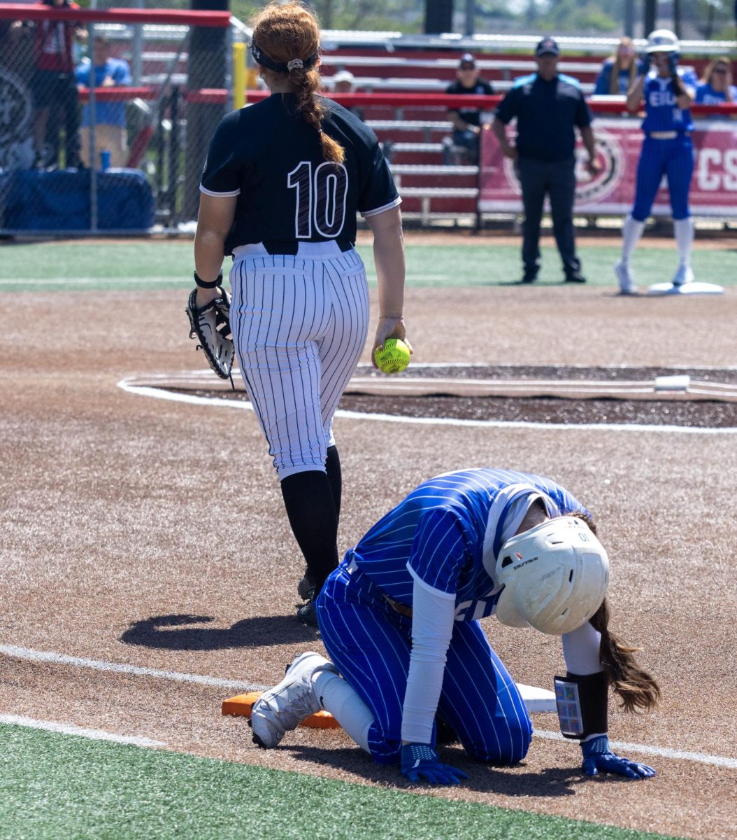 Eastern Illinois University softball junior catcher Sophia Olman (right) bows down in frustration after she gets caught out at first base by Lindenwood senior infielder Tori Hatton (left) during the first game of the OVC championship at OSF Healthcare Field at the Louisville Sports Sluggers Complex on Saturday.