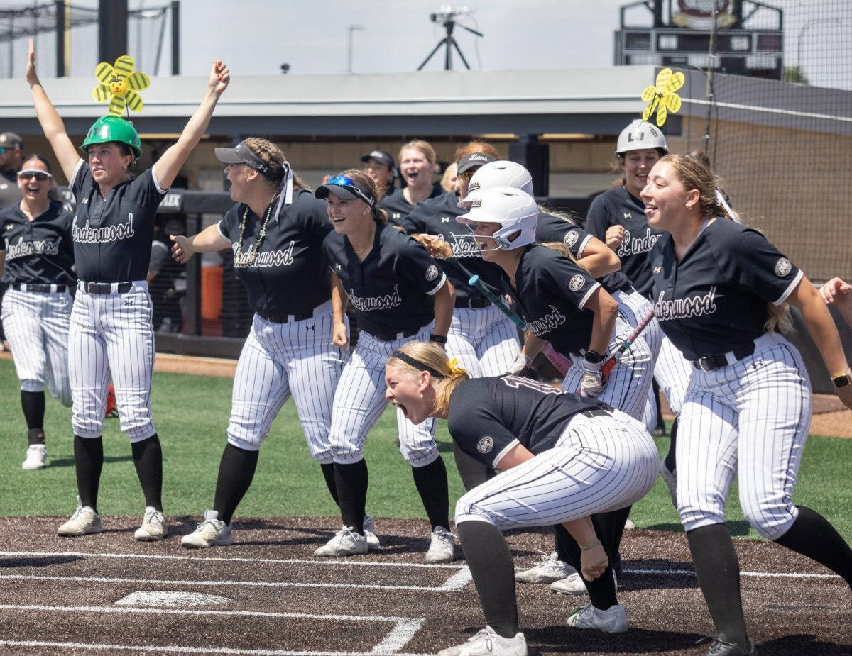 Lindenwood softball team gathers in celebration at home plate after a home run during the first game of the OVC championship at OSF Healthcare Field at the Louisville Sports Sluggers Complex on Saturday.