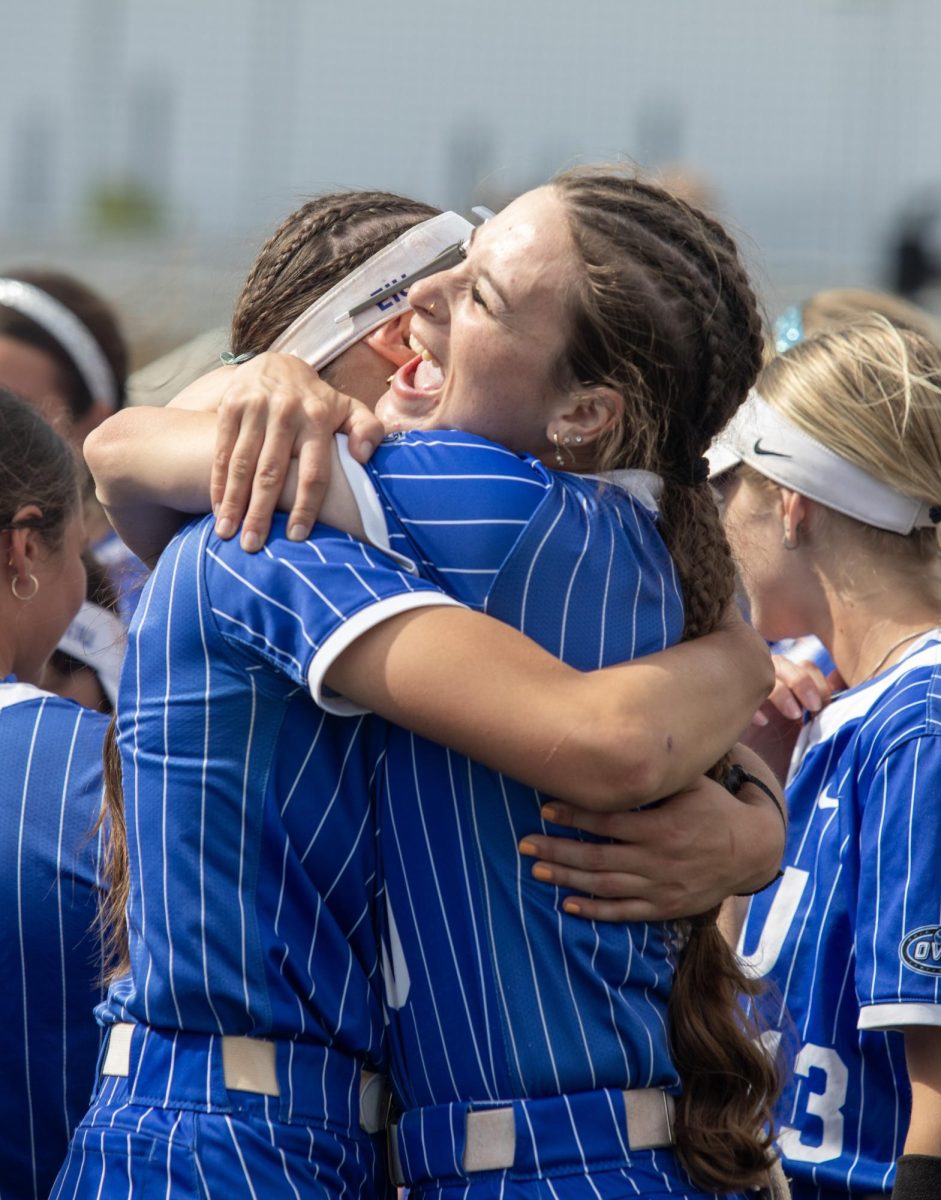 Eastern Illinois University softball junior catcher Sophia Olman (right) hugs with junior infielder Chloe Wamboldt (left) after winning the OVC championship at OSF Healthcare Field at the Louisville Sports Sluggers Complex on Saturday.