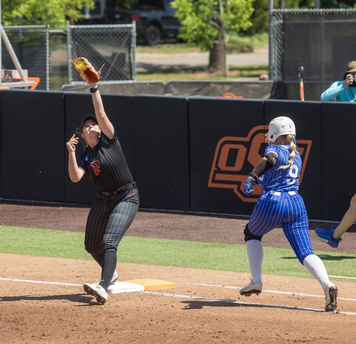 Princeton University freshman infielder Camryn Bradshaw (left) snags the ball to get Eastern Illinois University freshman infielder Viola Smith (right) out at first during EIU’s 2-1 loss to Princeton at Cowgirl Stadium on Saturday.