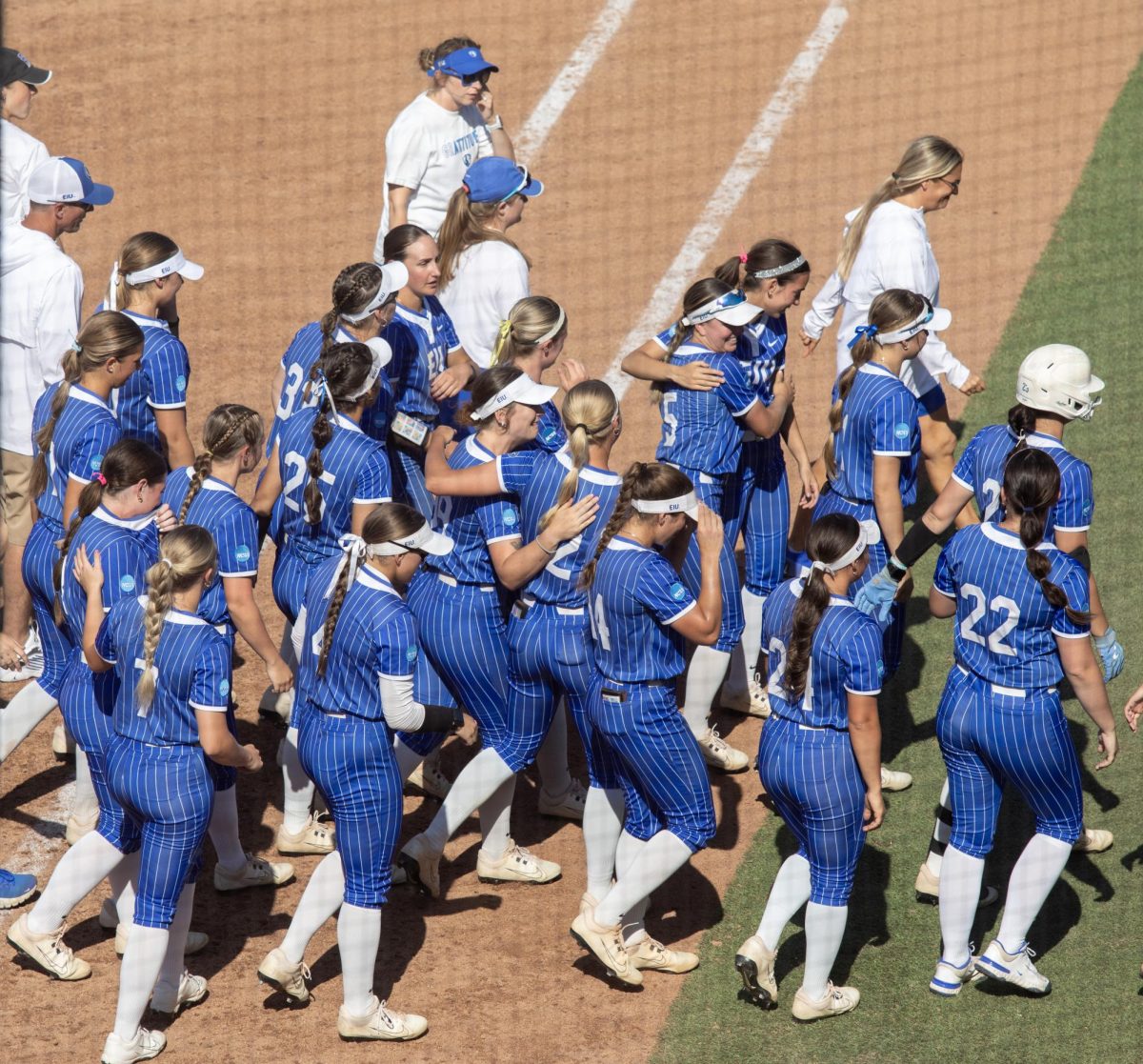 The Eastern Illinois University softball team consoles each other as they walk off the field for the last time this season after EIU’s 2-1 loss to Princeton University at Cowgirl Stadium on Saturday.