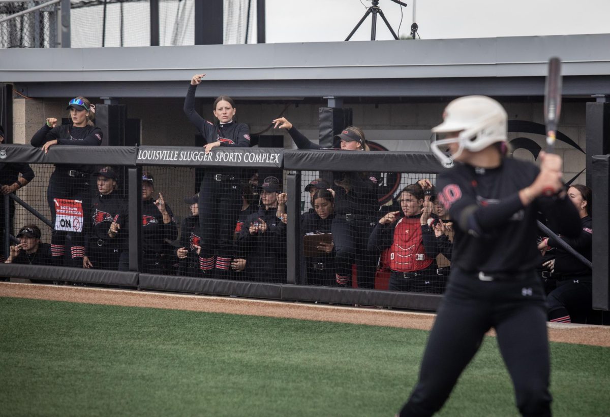 The Southeast Missouri State softball team cheers on its hitter, freshman infielder Sydney Miles during Eastern Illinois University’s 7-6 win against Southeast Missouri State in the first round of the Ohio Valley Conference tournament at OSF Healthcare Field at the Louisville Sports Sluggers Complex on Thursday.