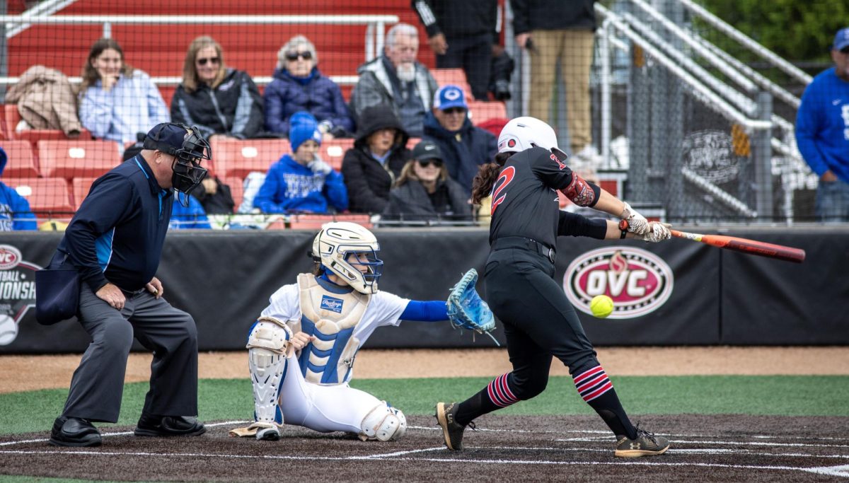  

Eastern Illinois University softball junior catcher Sophia Olman (left) catches a pitch while Southeast Missouri State senior outfielder Madison Winkler (right) swings at it during EIU’s 7-6 win against Southeast Missouri State in the first round of the Ohio Valley Conference tournament at OSF Healthcare Field at the Louisville Sports Sluggers Complex on Thursday.