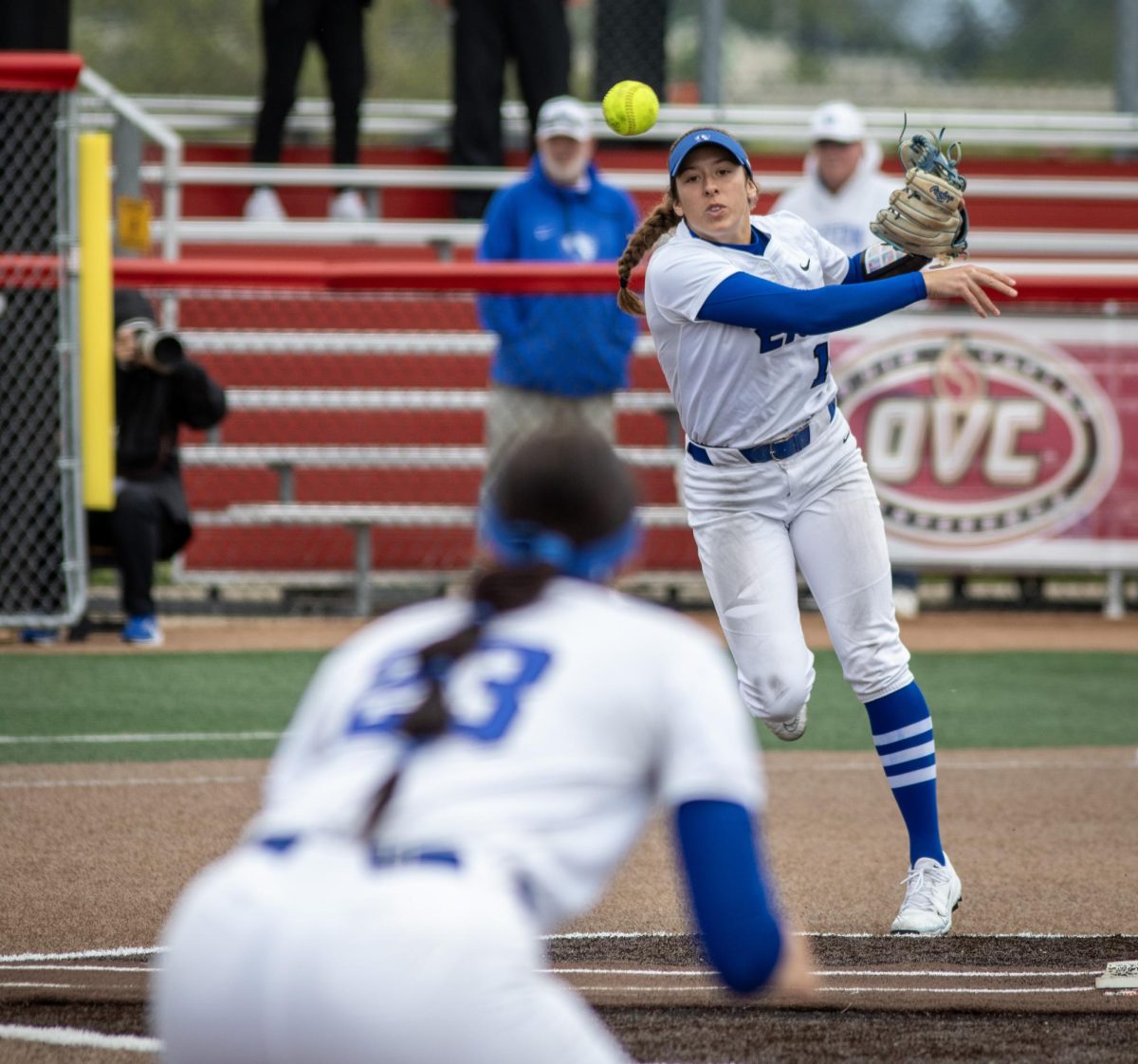 Eastern Illinois University softball junior infielder Chloe Wamboldt (back) throws a ball to sophomore utility player Abbi Hatton (front) at first base during EIU’s 7-6 win against Southeast Missouri State in the first round of the Ohio Valley Conference tournament at OSF Healthcare Field at the Louisville Sports Sluggers Complex on Thursday.