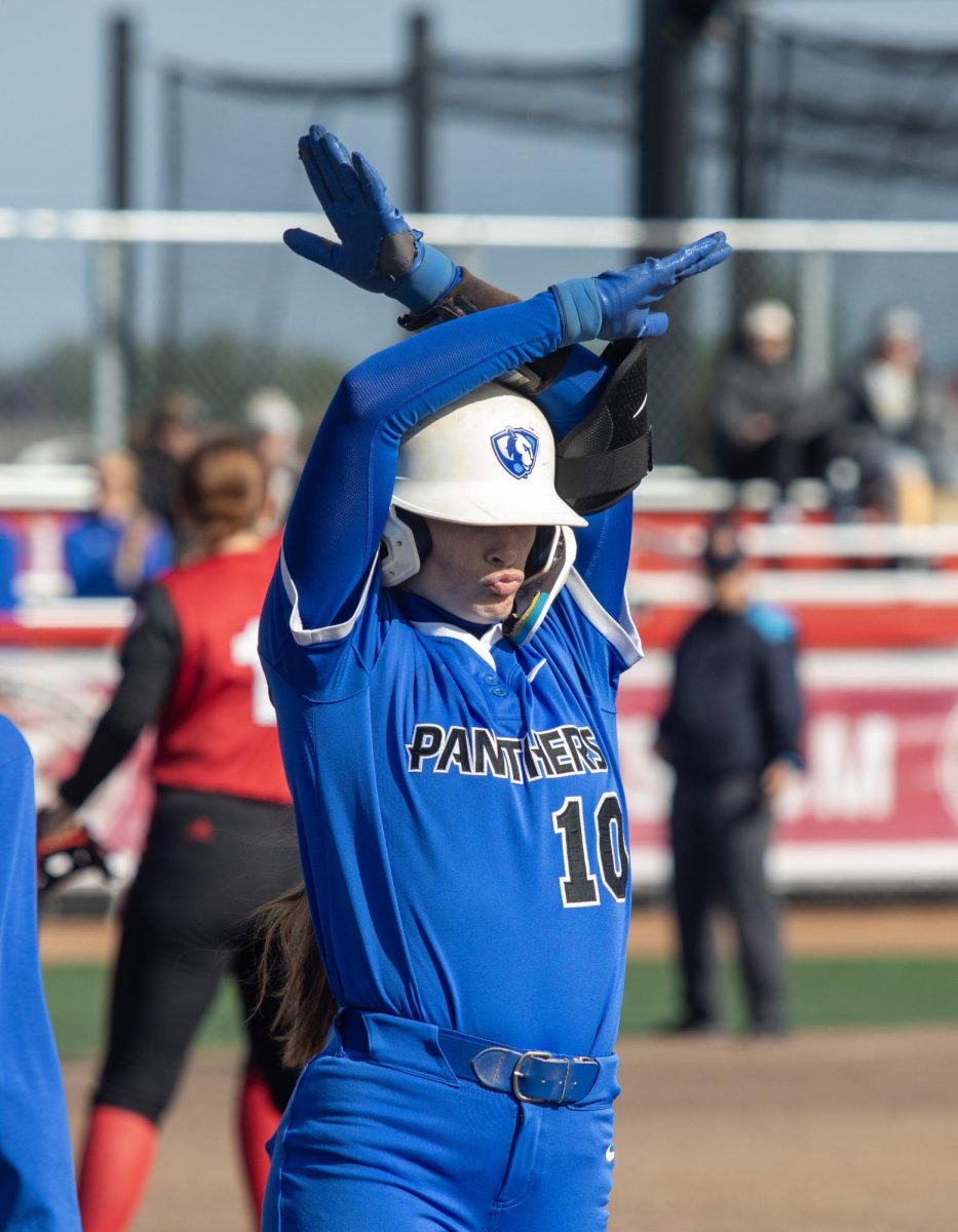 Eastern Illinois University softball junior catcher Sophia Olman does a celebratory pose after reaching first base during EIU’s 8-0 win against Southern Illinois Edwardsville in the semifinals of the Ohio Valley Conference tournament at OSF Healthcare Field at the Louisville Sports Sluggers Complex on Friday.