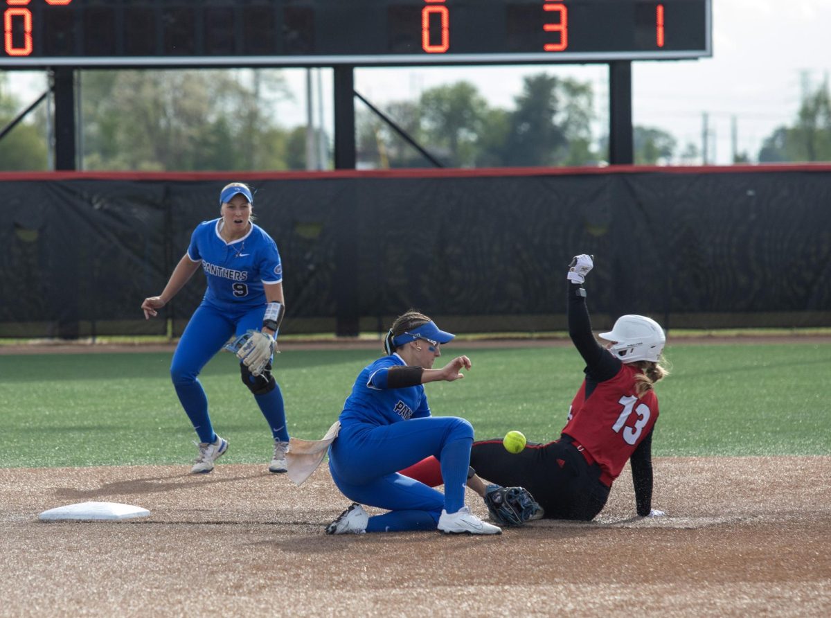 Eastern Illinois University softball junior infielder Chloe Wamboldt (left) tries to tag Southern Illinois University Edwardsville sophomore outfielder Abby Harvell (right) as Harvell slides into second base during EIU’s 8-0 win against SIUE in the semifinals of the Ohio Valley Conference tournament at OSF Healthcare Field at the Louisville Sports Sluggers Complex on Friday.