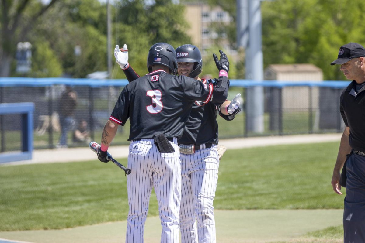 SIUE graduate student second baseman Mack Mitchell celebrates his first home run of the game with freshman teammate Cooper Eggert who also hit two home runs during SIUE’s 20-9 victory against EIU at Frost Field at Coaches Field on Sunday.