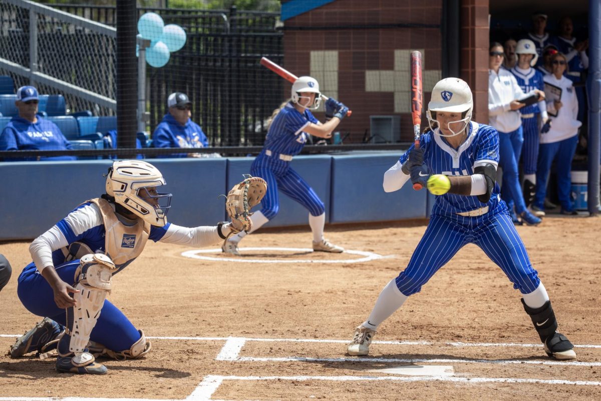 Eastern Illinois University softball senior infielder Lizzie Stiverson (right) looks at a ball goes past her into the glove of Tennessee State University junior catcher Mariah Brown (left) during EIU’s 15-0 win over TSU at Williams field on Saturday.