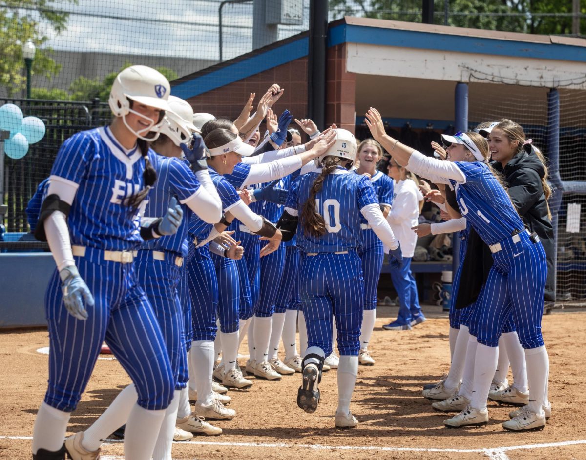 Eastern Illinois University softball junior catcher Sophia Olman runs through a tunnel of her teammates after her home run during EIU’s 15-0 win over Tennessee State University at Williams field on Saturday.