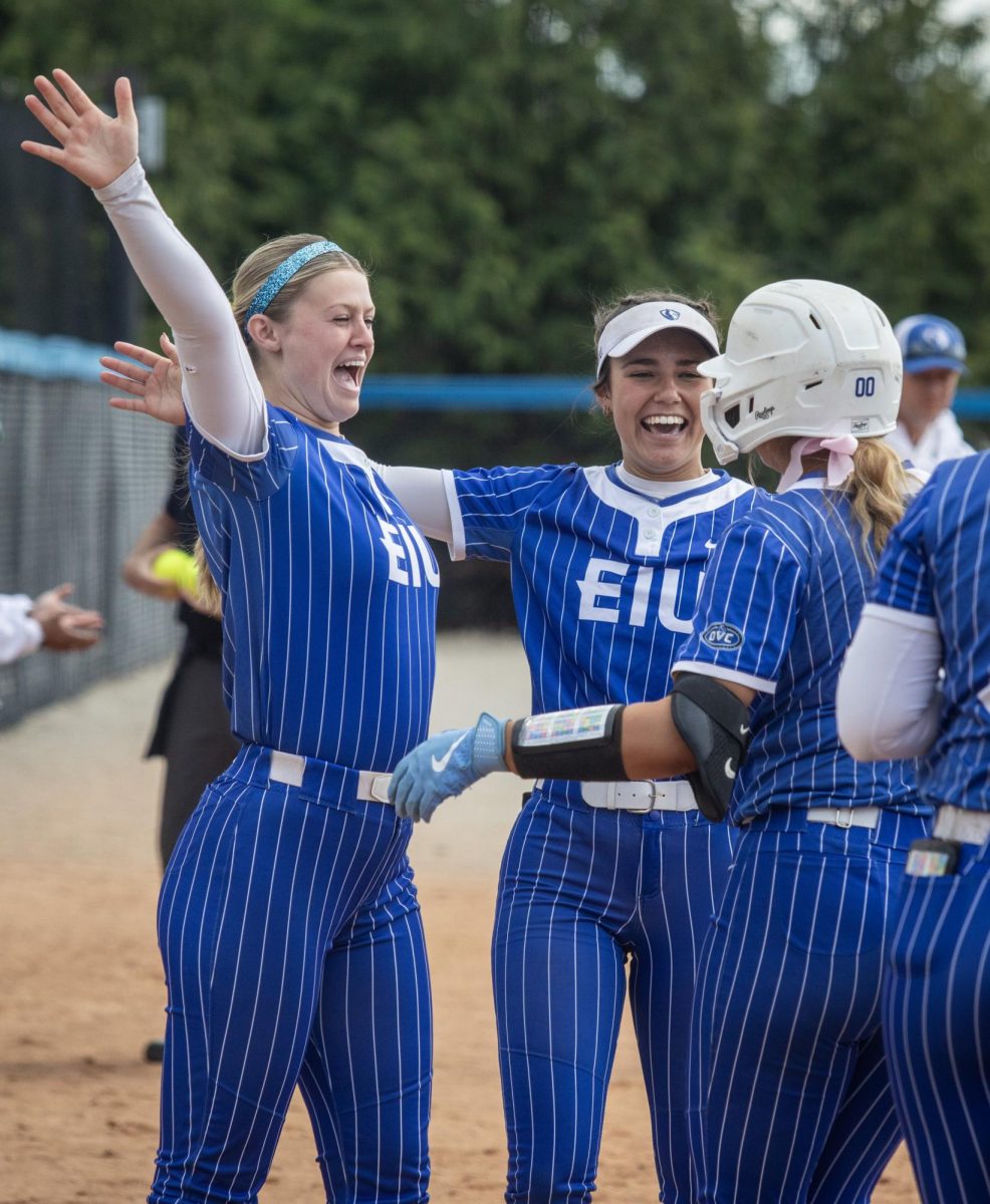 Eastern Illinois University softball sophomore infielder Maddux Marshall (left) hugs freshman utility player Adysen Rios (center) and freshman catcher Peyton Dwigans (right) after Dwigans hit her second home run of the year during EIU’s 15-0 win over Tennessee State University at Williams field on Saturday.
