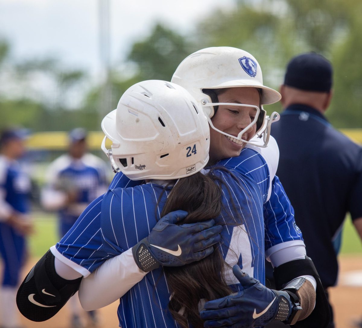 Eastern Illinois University softball senior infielder Lizzie Stiverson (right) hugs junior infielder Hillary Springer (left) after Stiverson hit a home run during EIU’s 15-0 win over Tennessee State University at Williams field on Saturday.