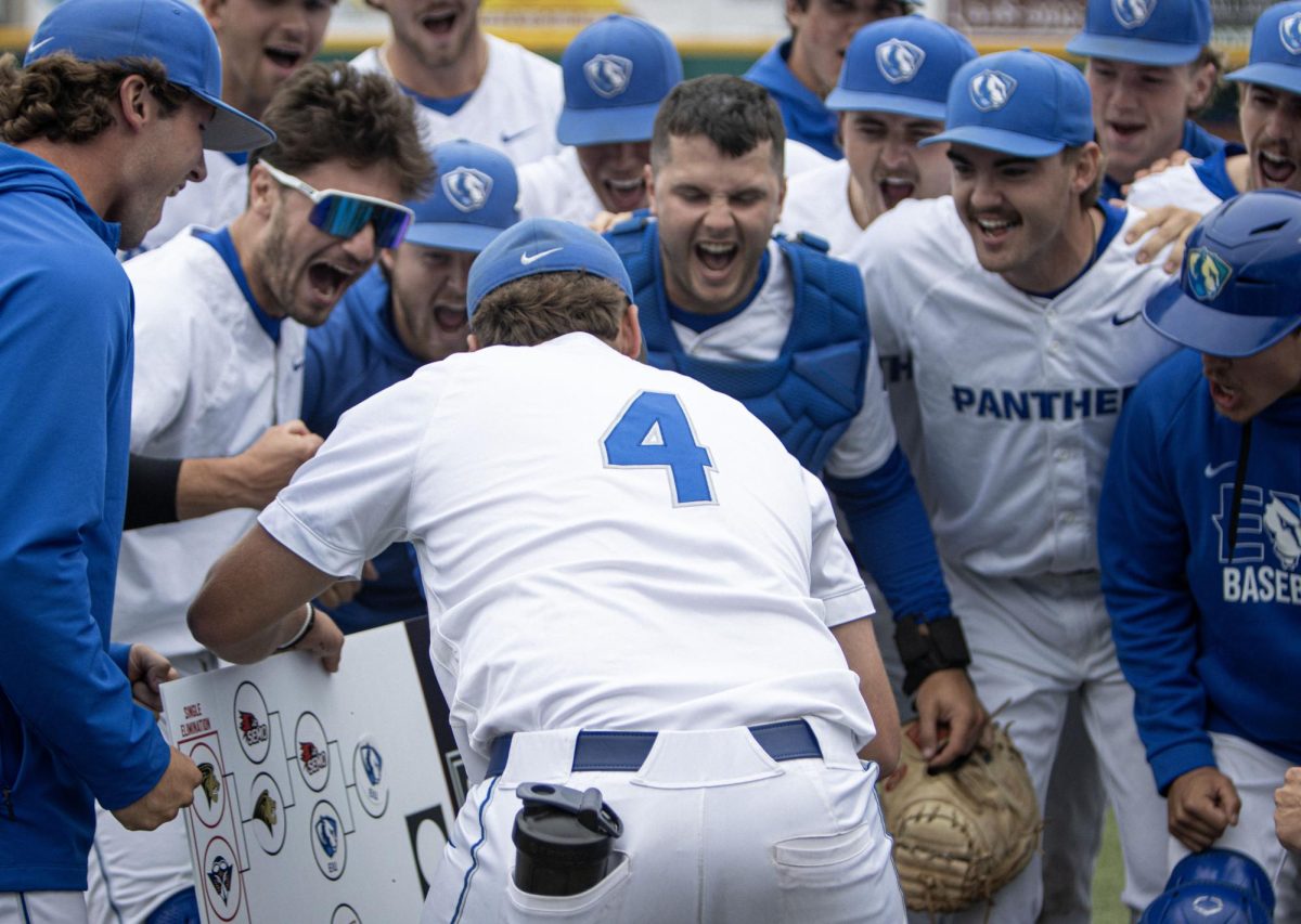 The Eastern Illinois University baseball team celebrates as junior right-handed pitcher Bryce Riggs places their logo on the OVC tournament bracket after Eastern’s 3-2 win over Southeast Missouri in the OVC tournament.