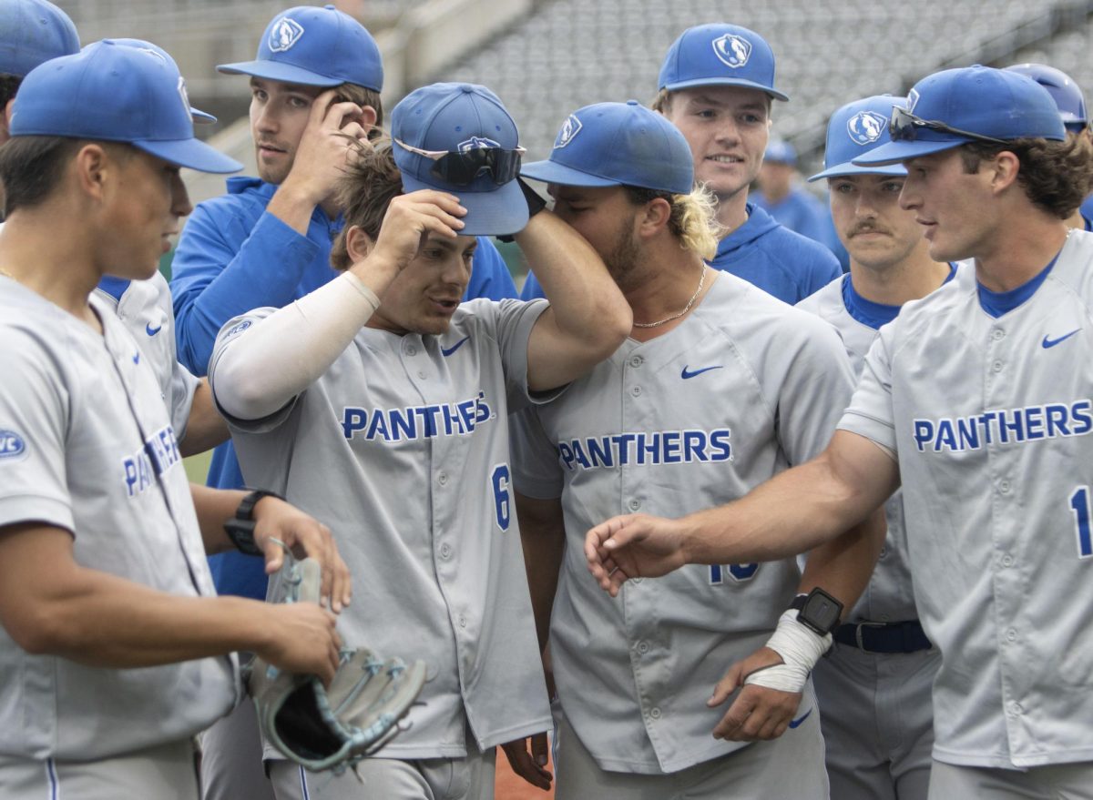 Eastern Illinois University graduate center fielder Quade Peters celebrates with graduate left fielder Brett Stanley after Eastern’s 3-2 win over Southern Illinois Edwardsville in the Ohio Valley Conference tournament.