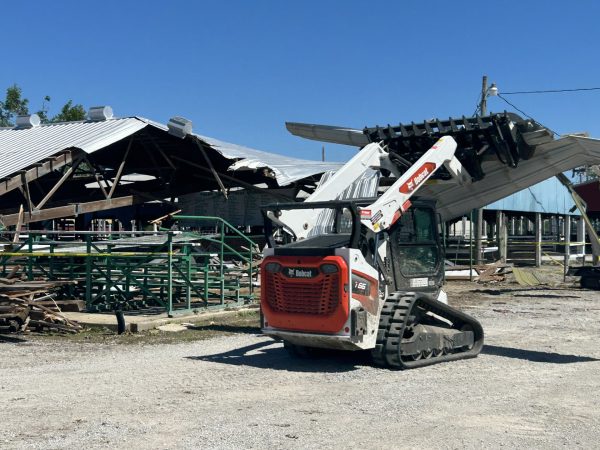 Volunteers clean up the debris of the show arena at the Coles County Fairgrounds on Friday after the tornado hit Charleston Wednesday night.
